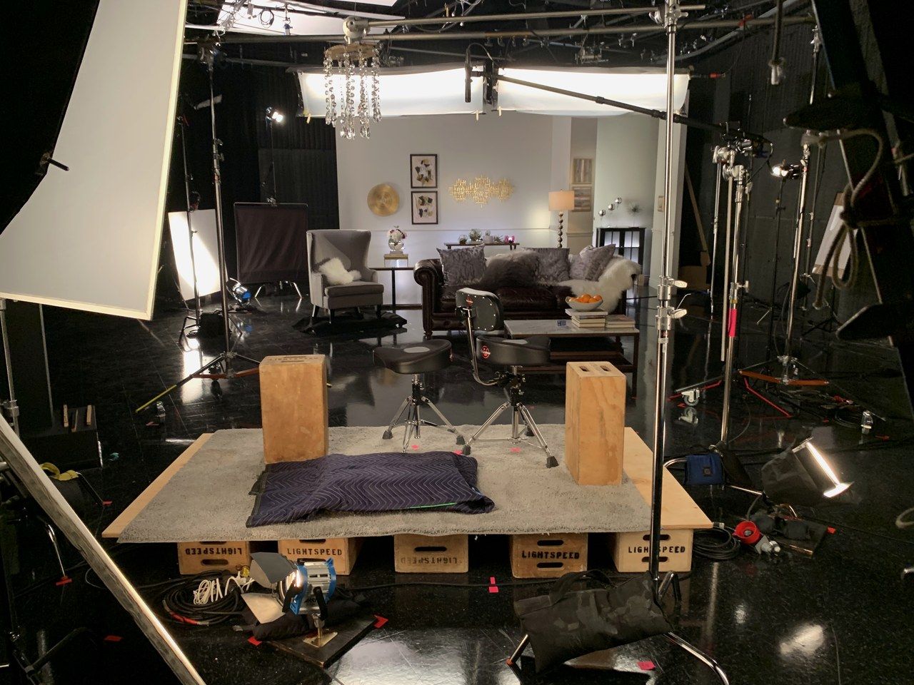 Studio floor set up with camera, jib, and lighting